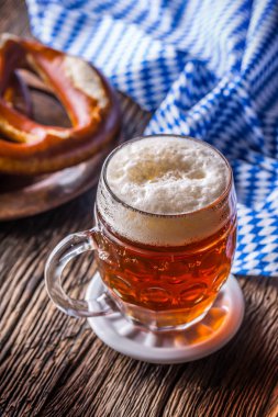 Bira ve Oktoberfest. Taslak bira simit ve mavi kareli masa örtüsü olarak Bavyera Festivali için geleneksel ürünleri oktoberfest