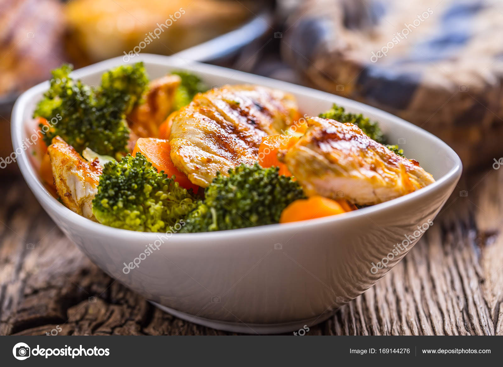 Chicken and vegetable salad. Pieces of grilled chicken with carrots and