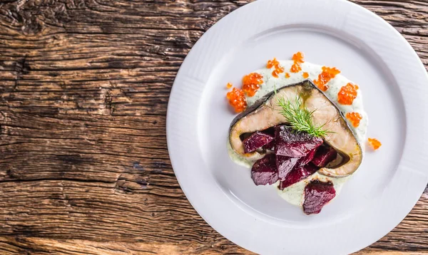 Sturgeon fillet with caviar beetroot and dill on plate in hotel or restaurant — Stock Photo, Image