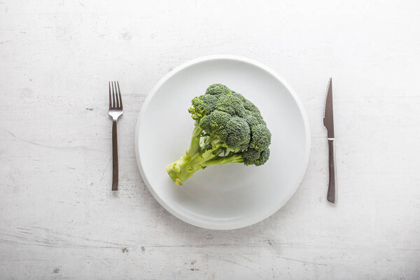 Top of view broccoli on plate with fork and knife