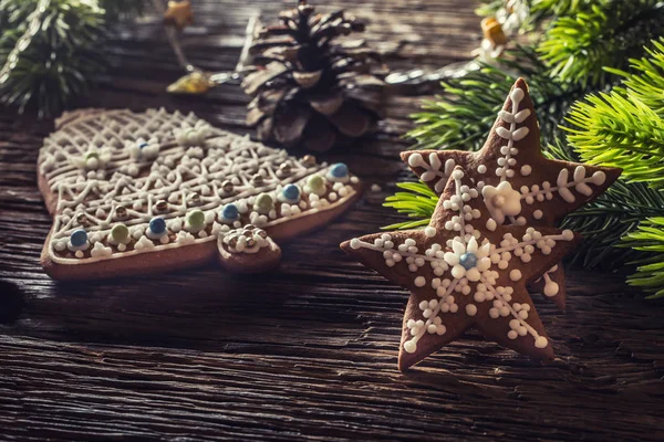 Christmas cake ginderbread. Christmas stars bell cakes and decoration on rustic oak table