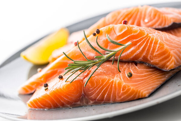 Salmon. Raw salmon steaks herb peper lemon on white background.