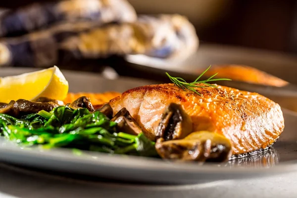 Salmon Roast Fillet. Portion of roast salmon fillet with spinach mushrooms in restaurant pub home or hotel — Stock Photo, Image