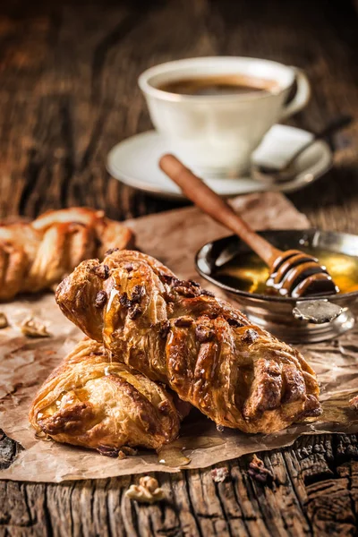 Sweet Pastry. Sweet pie honey cup of coffee on wooden table. Sweet breakfast