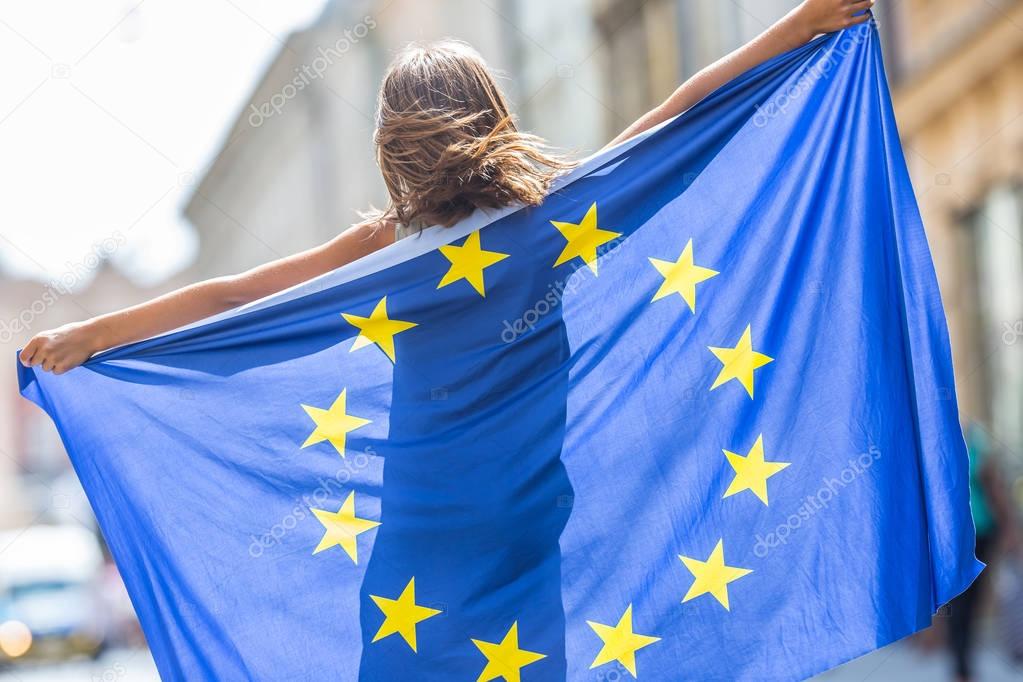 EU Flag. Cute happy girl with the flag of the European Union. 