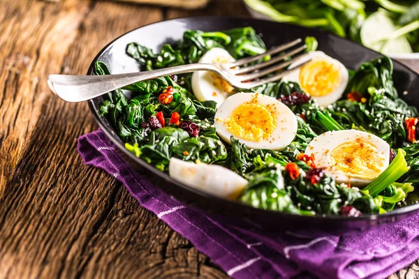Spinach Salad. Fresh spinach salad with eggs chili pepper and sw