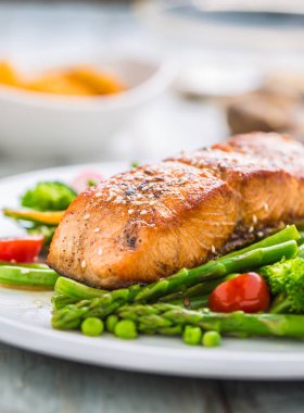 Asparagos brokoli havuç domates turp yeşil fasulye ve bezelye ile kavrulmuş somon steak. Balık unu taze sebze ile