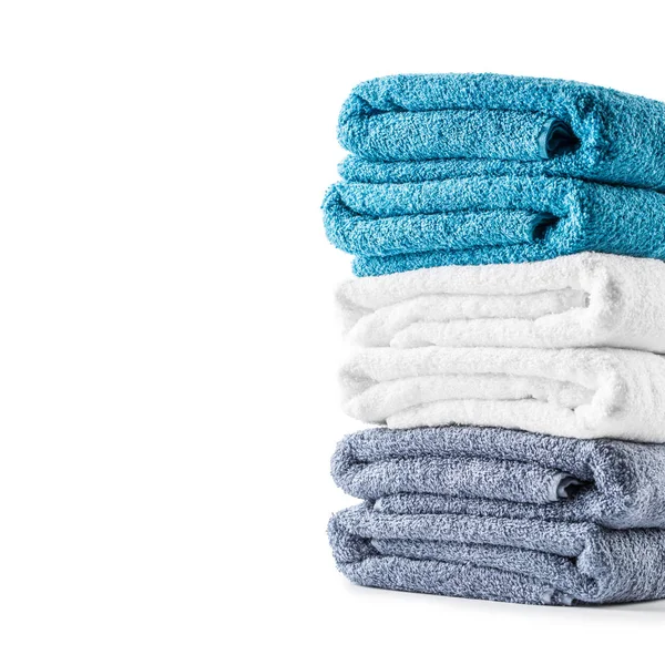 Stacked blue white and gray towels isolated on white — Stock Photo, Image