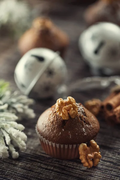 Christmas chocolate delicious muffins sprinklad with sugar powder and wallnut on top — Stock Photo, Image