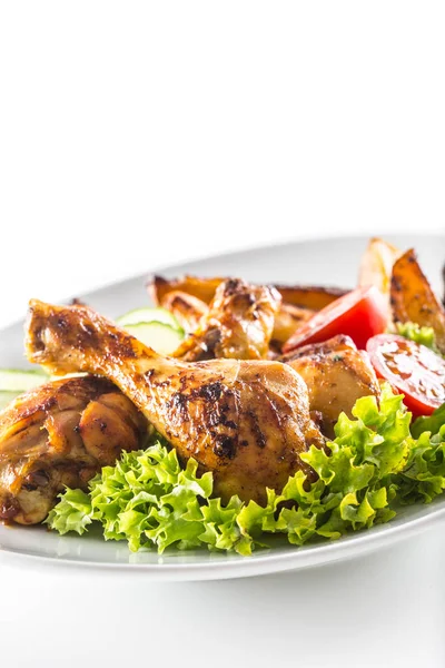 Roasted chicken legs with lettuce salad potatoes and tomatoes isolated on white — Stock Photo, Image
