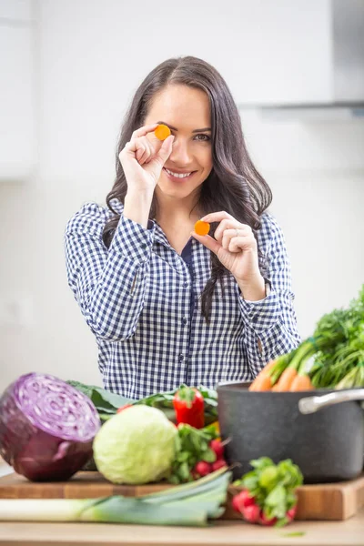 在厨房里拿着胡萝卜片的活泼的年轻女人 饮食蔬菜和健康概念 — 图库照片
