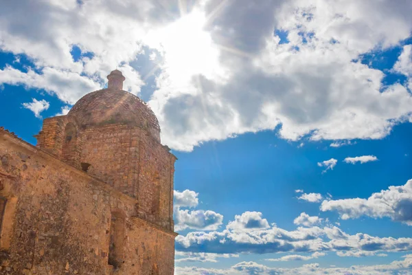 Old church on a background of blue sky with clouds