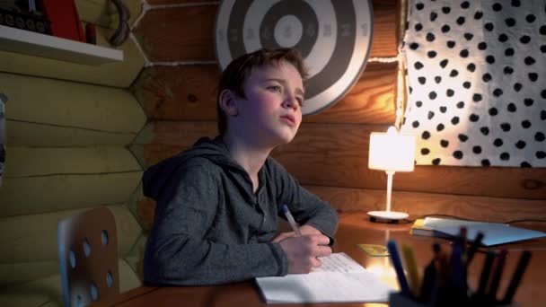 Studying at Home. Boy Is Doing His Homework Alone. Camera Sliding. — Stock Video