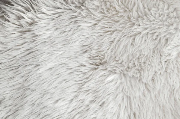 Pink sheepskin rug background. Wool texture. Close up sheep fur