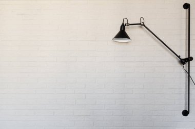 Beyaz tuğla zemin üzerine siyah lamba. İç parçası. Kopya alanı