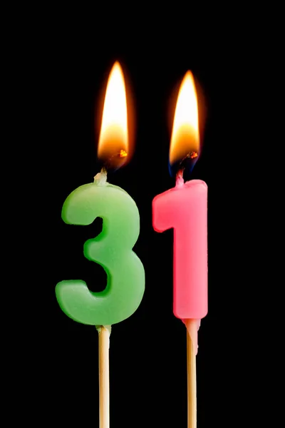 Burning candles in the form of 31 thirty one (numbers, dates) for cake isolated on black background. The concept of celebrating a birthday, anniversary, important date, holiday, table setting — Stock Photo, Image