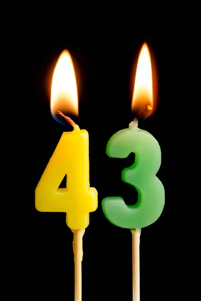 Burning candles in the form of 43 forty three (numbers, dates) for cake isolated on black background. The concept of celebrating a birthday, anniversary, important date, holiday, table setting — Stock Photo, Image