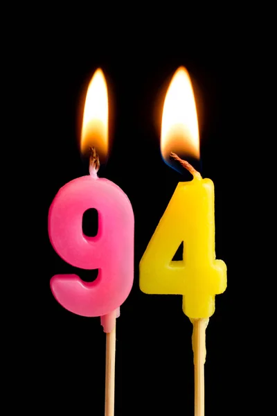 Burning candles in the form of 94 ninety four (numbers, dates) for cake isolated on black background. The concept of celebrating a birthday, anniversary, important date, holiday, table setting — Stock Photo, Image