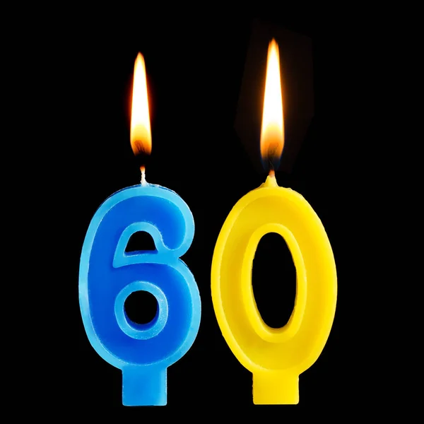 Queimando velas de aniversário na forma de 60 sessenta números do bolo isolado no fundo preto. O conceito de celebrar um aniversário, aniversário, data importante, feriado, configuração de mesa — Fotografia de Stock