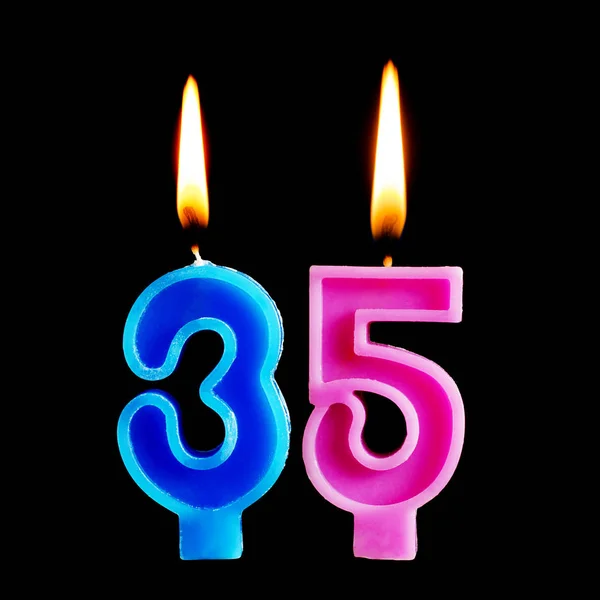 Зажигание свечей на день рождения в виде 35 тридцати пяти цифр для торта изолированы на черном фоне. Концепция празднования дня рождения, юбилея, важной даты, праздника — стоковое фото