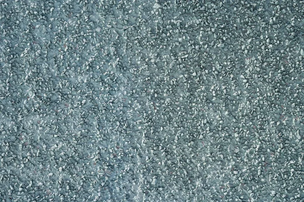 The texture of the plastered surface with a fine gravel of gray color.