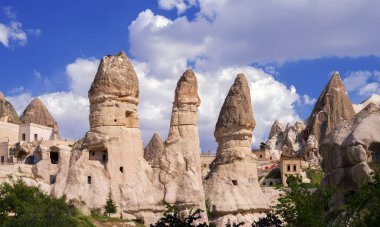 Housing and hotels arranged in sandstone formations in Goreme. Cappadocia, Turkey. clipart