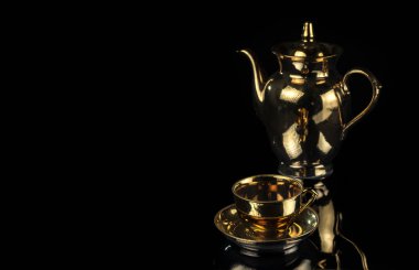 Siyah arka planda izole edilmiş çay fincanı ve çaydanlık. Seçici odak.