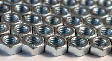 Aynı metal ve iplikli fındıklar. Metal doku. Seçici odak.