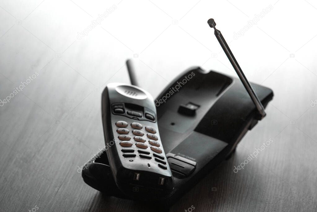 Wireless cordless telephone on the table. Selective focus.