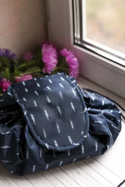 cosmetic bag, big cosmetic bag, bag for cosmetic, navy cosmetic bag, blue cosmetic bag, little blue bag, little bag, bag for girl, bag for woman, bag, bag in blue, bags, bags for woman, bags in different colors, bags on the window, blue, blue bag