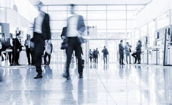blurred people at a trade fair hall