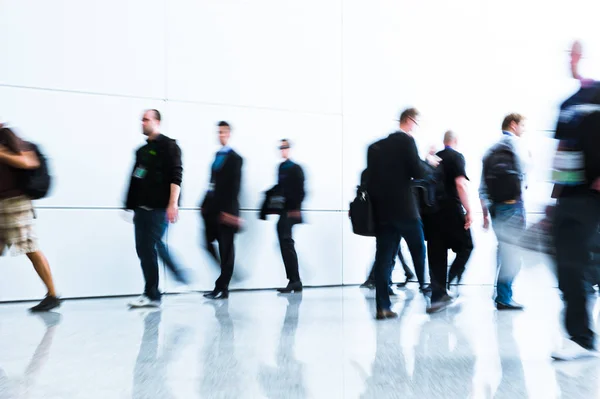 blurred people at a trade fair hall