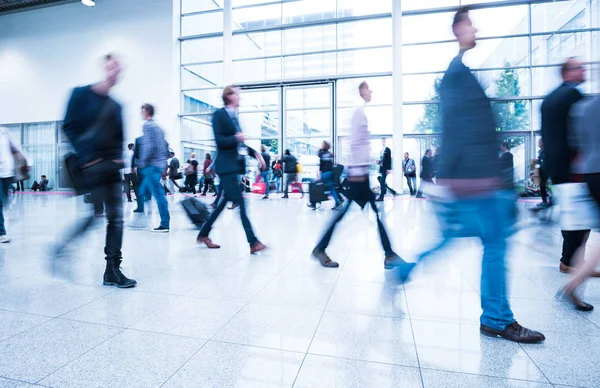 blurred people at a trade fair hall