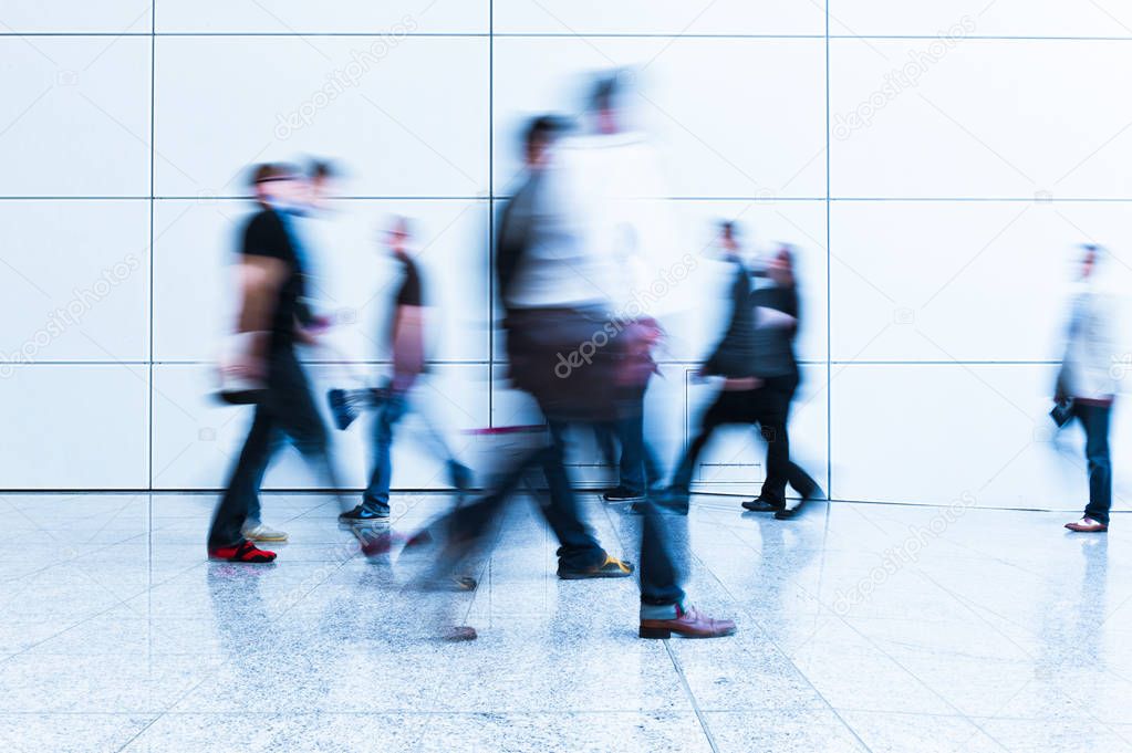 blurred people at a trade fair hall