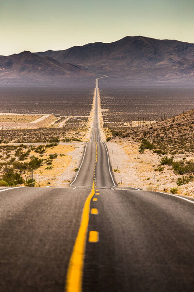 Endless straight road in Death Valley National Park, California, USA