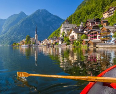 Classic view of Hallstatt with traditional rowing boat in summer, Austria clipart