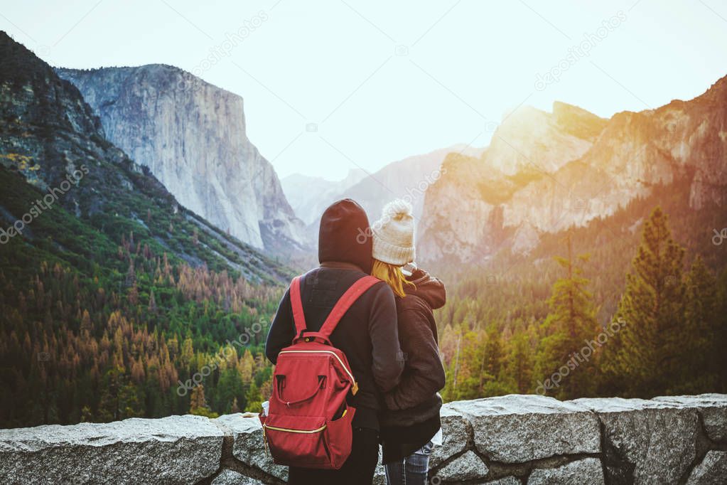 Young lovers watching sunrise in Yosemite National Park, California, USA