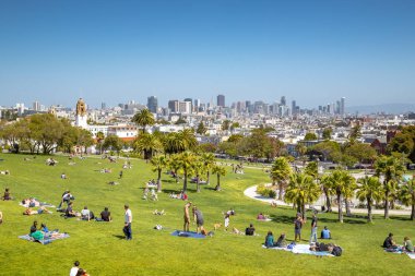 People enjoying sunny weather in Mission Dolores Park, San Francisco, USA clipart