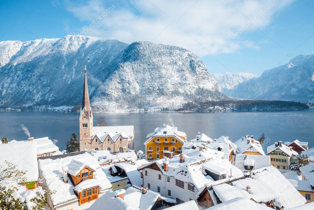 Panoramic view of the historic village of Hallstatt on a beautiful cold sunny day with blue sky and clouds in winter, Austria