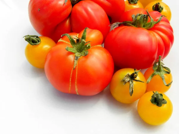 fresh red tomatoes on white background. yellow cherry tomatoes