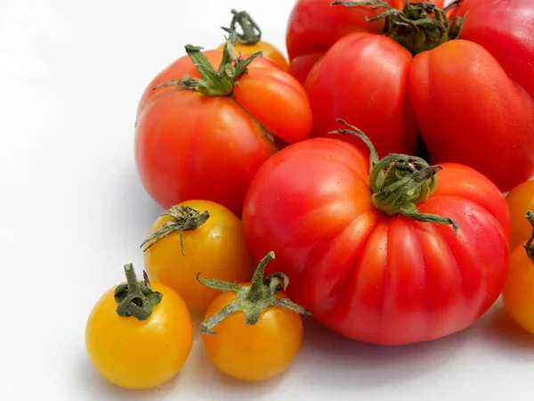 fresh red tomatoes on white background. yellow cherry tomatoes