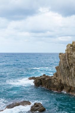 beautiful cliffs and picturesque seascape in Riomaggiore, Italy clipart