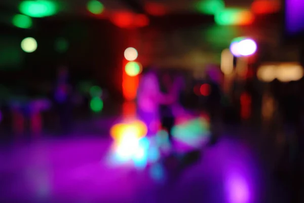 Dancefloor background bokeh with dancers with a few highlights on the subject — Stock Photo, Image