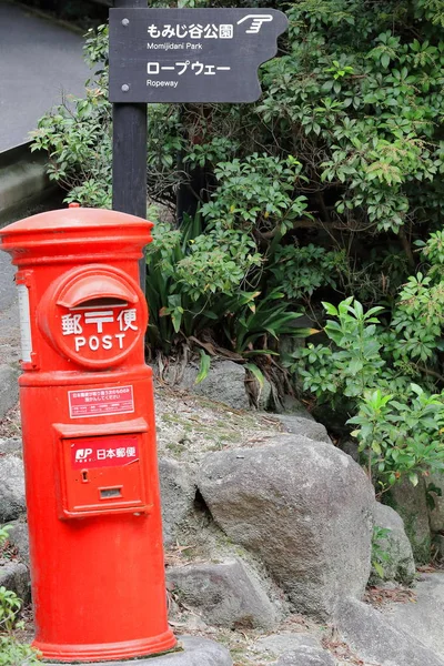 Rozcestník a červené Japan Post poštovní schránka. Miyajima Japonsko. 6965 — Stock fotografie