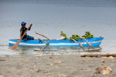 Boy in dugout towboat. Lamen Bay-Epi island-Vanuatu. 5461 clipart