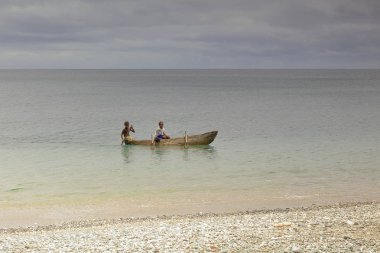 Local boys paddling a dugout canoe. Panngi-Pentecost island-Vanuatu. 6475 clipart