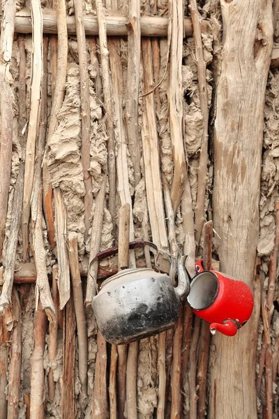 Plain Metal Red Enamel Old Teapots Hanging Reeds Mud Wall — Stock Photo, Image