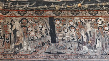 Remnants of painted frescoes-exterior wall of the cliff housing the Mogao caves rock cut into the local sandstone depicting Buddhist imagery spanning the 4th to the 14th century. Dunhuang-Gansu-China. clipart