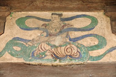 Fresco from the North Song dynasty of a musical Apsara-outer cliff wall of the Mogao caves hewn into the local sandstone showing Buddhist imagery from the 4th to the 14th century. Dunhuang-Gansu-China clipart