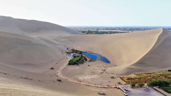 Crescent lake-Yueyaquan amidst Singing or Echoing Sand Mountain-Mingsha Shan. Oasis originally part of Danghe river left aside in a change of course-natural wonder of Gobi Desert. Dunhuang-Gansu-China
